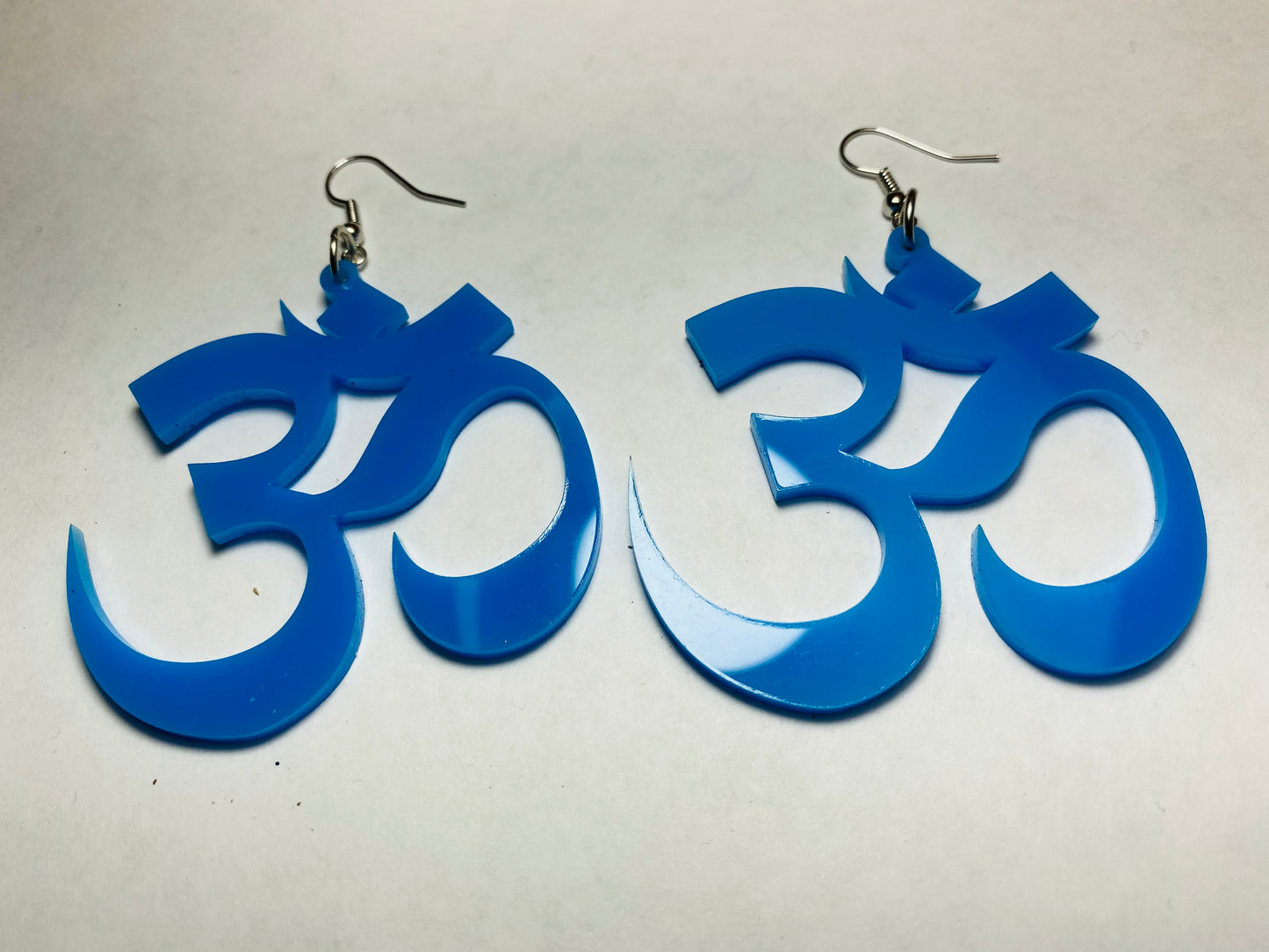 big blue om laser cut earrings